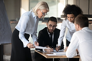 Group of lawyers negotiating and signing documents