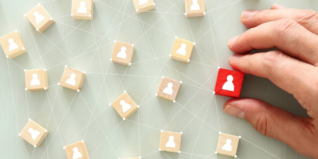 HR Outsourcing Solutions concept. A web of wooden blocks with people icon