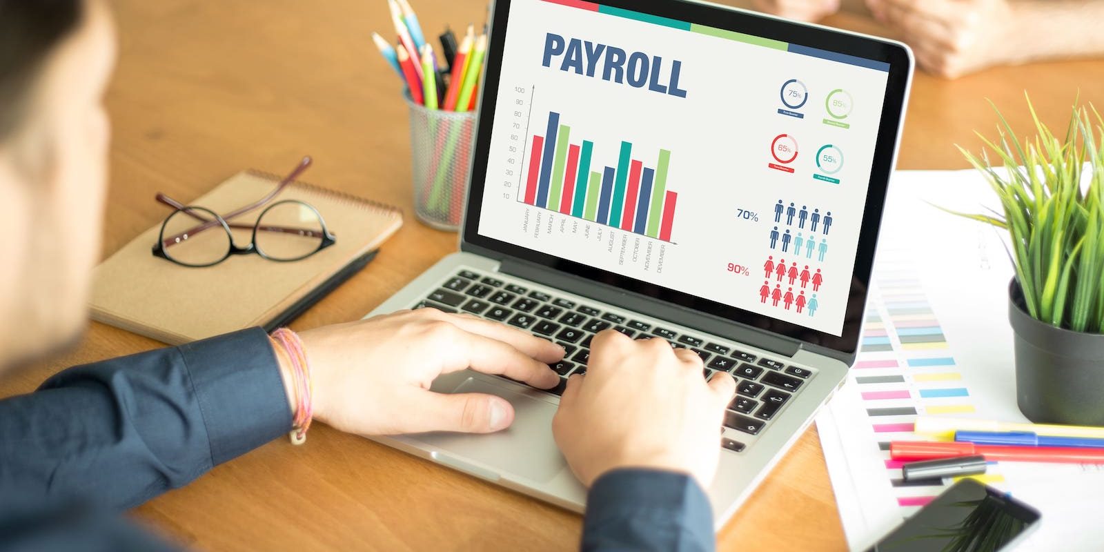 A business owner using software provided by a payroll management solutions firm