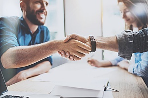 a handshake between a business owner and a consultant