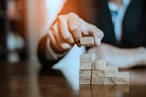 Business man hand building blocks