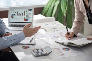 Two employees reading performance appraisals 